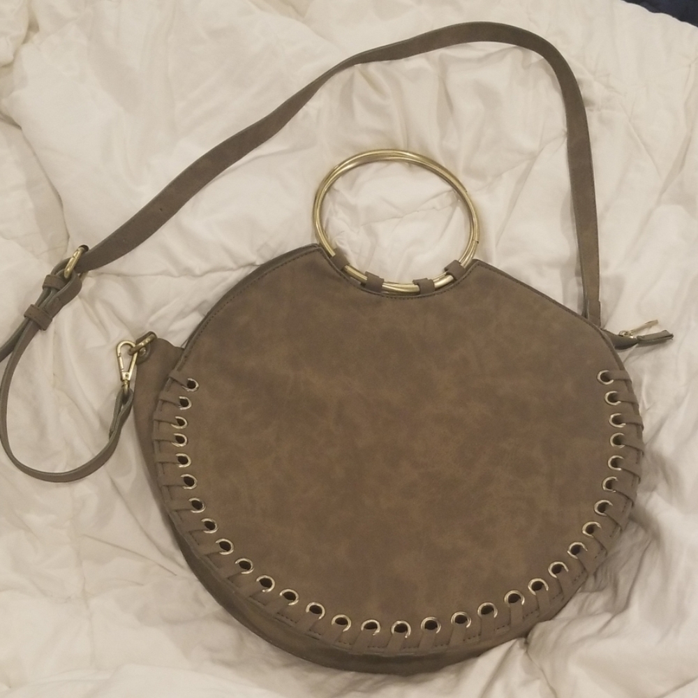 Suade whipstitched round bag with metal handle